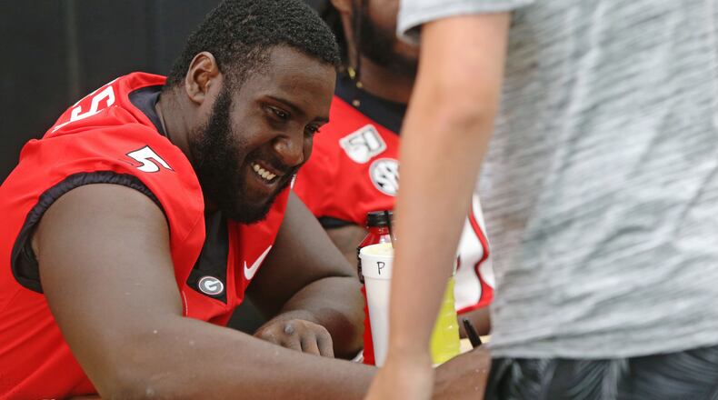 August 3, 2019 Athens- University of Georgia Julian Rochester smiles and signs posters during UGA Fan Day at the team's indoor practice facility in Athens, Georgia on Saturday, August 3, 2019. Fans came out in force to get posters autographed by their favorite players before the beginning of the 2019 season. Christina Matacotta/Christina.Matacotta@ajc.com