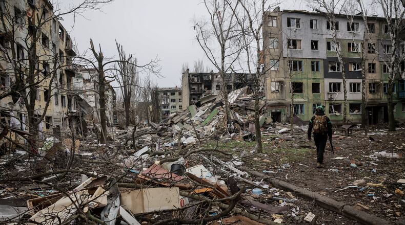 In this photo taken on Saturday Dec. 20, 2025 and provided by Ukraine's 24th Mechanized Brigade press service, a soldier walks through the ruins of the town of Kostyantynivka, in the Donetsk region, Ukraine. (Oleg Petrasiuk/Ukraine's 24th Mechanized Brigade via AP)