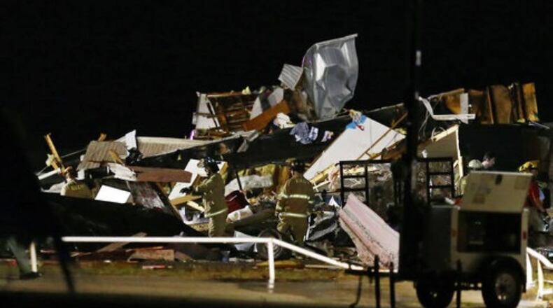 Emergency workers search through debris from a mobile home park in El Reno, Oklahoma, after a tornado hit the area.