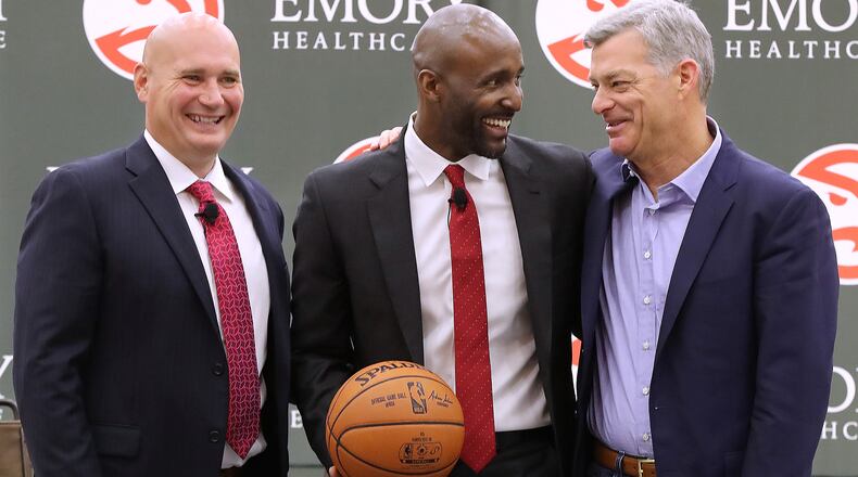 Atlanta Hawks general manager Travis Schlenk (left) and owner Tony Ressler (right) introduce Lloyd Pierce as the 13th full-time coach in the Atlanta history of the NBA basketball franchise on Monday, May 14, 2018, in Atlanta.