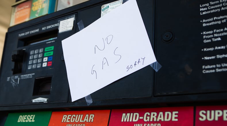 Notes are taped to empty gas pumps Thursday at a Chevron gas station on Canton Road in Marietta. Motorists throughout the Southeast still struggled to find gas due to the shutdown of the Colonial Pipeline distribution network last Friday after a cyberattack.