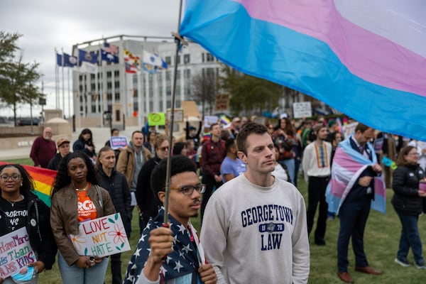 Kay Fonville (left front) and Austin Coe (right front) participate in a rally outside the Capitol in Atlanta on Tuesday, March 4, 2025, as groups stage a protest and “lobby day” to protest anti-LGBTQ measures. (Arvin Temkar/AJC)