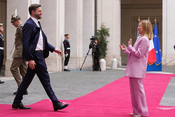 U.S. Vice President JD Vance, left, is welcomed by Italian Premier Giorgia Meloni as he arrives for talks at Palazzo Chigi government office in Rome, Friday, April 18, 2025. (AP Photo/Andrew Medichini)