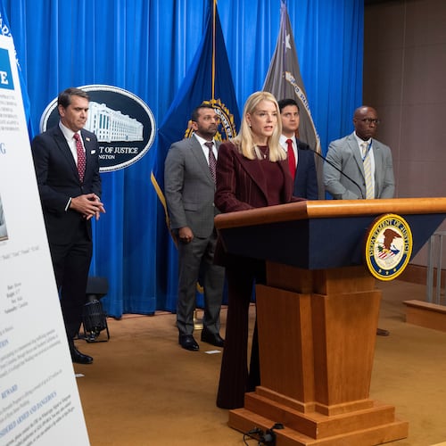 Attorney General Pam Bondi stands near wanted poster for Canadian fugitive Ryan James Wedding as she speaks with reporters during a news conference at the Department of Justice, Wednesday, Nov. 19, 2025, in Washington. (AP Photo/Mark Schiefelbein)