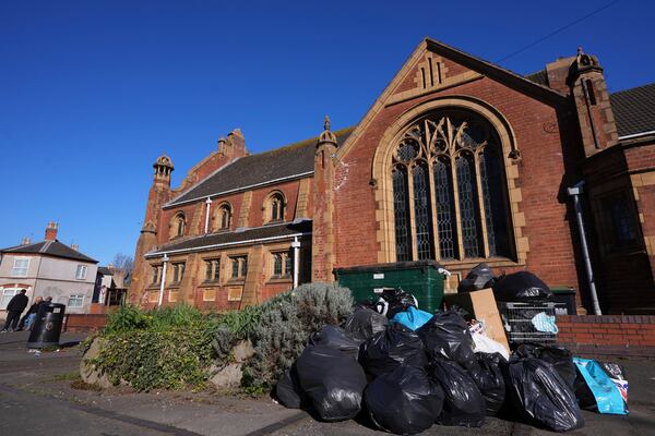 Rubbish piles up on a residential street in Birmingham, England, Monday, April 7, 2025, amid an ongoing refuse workers' strike in the city. (AP Photo/Kirsty Wigglesworth)