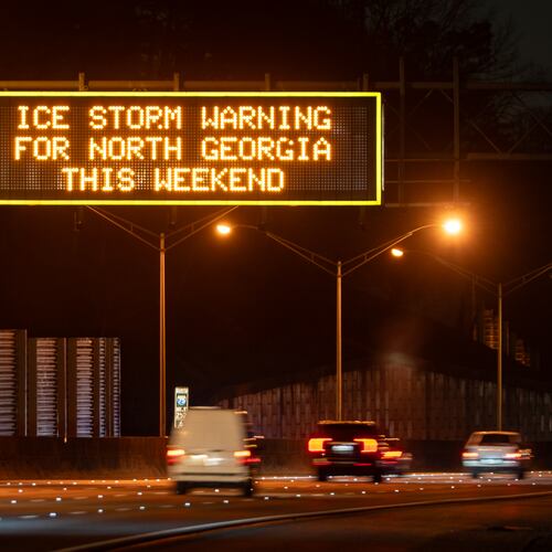 A Georgia Department of Transportation sign over I-75 warns Saturday of the impending ice storm that will hit North Georgia this weekend. (Ben Hendren for the AJC)