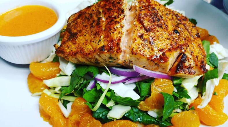 Grilled Norwegian salmon salad with blood orange dressing from the menu of Corner Grille. / Corner Grille Facebook page