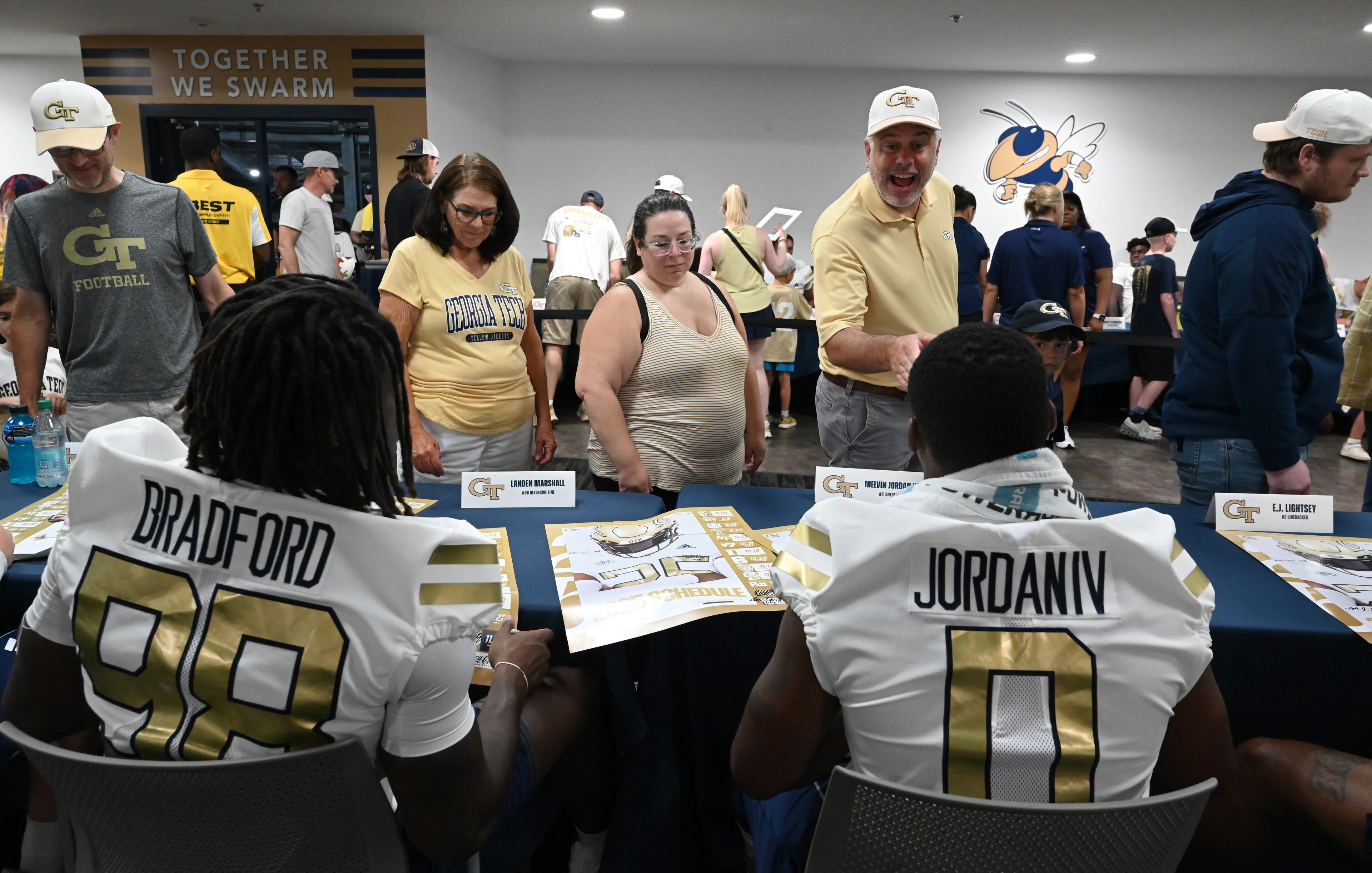 Georgia Tech football players sign autographs for event attendees during the annual “First Saturday on The Flats” at Bobby Dodd Stadium, Saturday, August 2, 2025, in Atlanta. The Flats provides Tech fans with the opportunity to engage with their favorite Yellow Jackets ahead of the upcoming 2025 season. The event offers a variety of entertaining activities for the whole family, including a DJ, autograph opportunities, tailgate games and interactive experiences right on the field at Bobby Dodd Stadium. (Hyosub Shin / AJC)