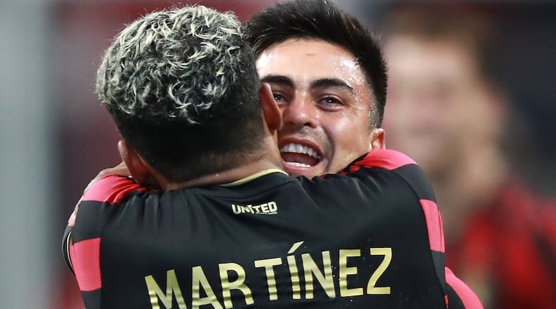 Atlanta United midfielder Pity Martinez (right), who scored the first goal of the game, gives forward Josef Martinez (left) a hug after his goal while celebrating their 2-0 victory over D.C. United in a soccer match on Sunday, July 21, 2019, in Atlanta. Curtis Compton/ccompton@ajc.com