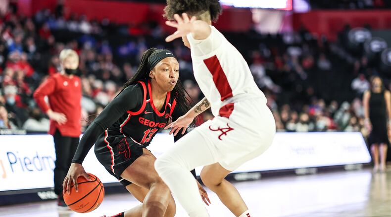 Georgia guard Tineya Hylton (13), here showing her dribbling skills against Alabama at Stegeman Coliseum in early January, drew a charge and executed a steal in the final 10 seconds of play to help the Bulldogs clinch a 63-62 win over Arkansas in Fayetteville, Ark., on Thursday night. (Photo by Mackenzie Miles/UGA Athletics)