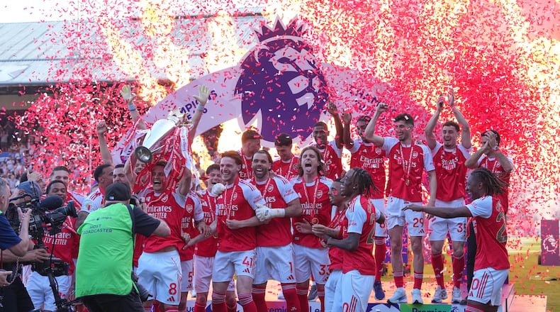 Arsenal players celebrate their Premier League title with the trophy after the English Premier League soccer match between Crystal Palace and Arsenal in London, England, Sunday, May 24, 2026. (AP Photo/Kin Cheung)