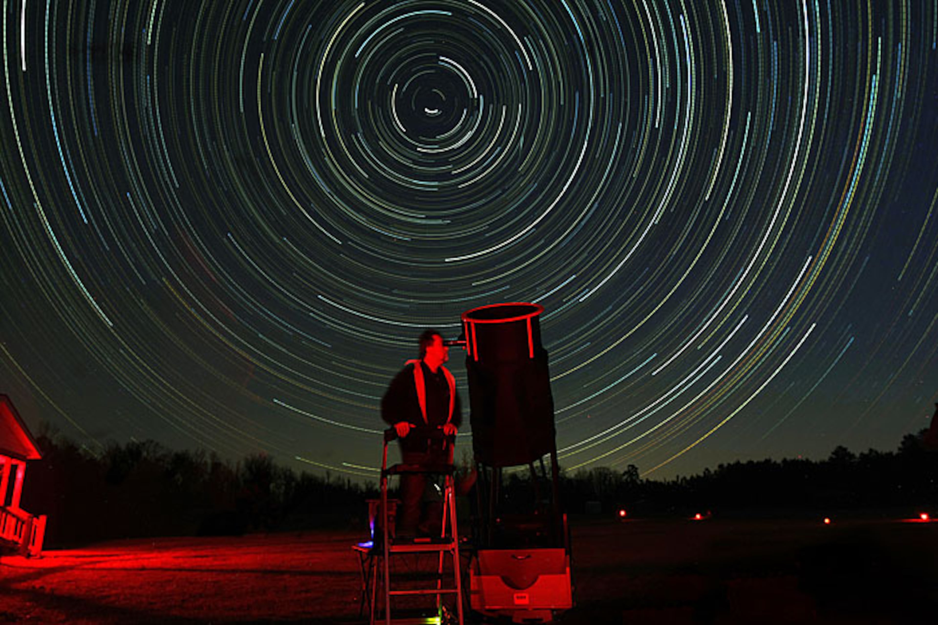 Star trails streak through the sky as Dan Llewellyn, 46, Decatur, lines up his 20-inch Star Master telescope to photograph Mars and Saturn outside his cabin at the Deerlick Astronomy Village in Sharon on Friday, March 19, 2010. The "Star Trails" in the sky are created by the movement of the earth during a 5-hour time exposure while the photographer's camera remains fixed on a tripod.
