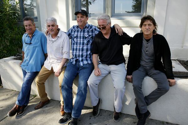 FILE - In this Friday, April 13, 2018, photo, the Waldos, from left, Mark Gravitch, Larry Schwartz, Dave Reddix, Jeffrey Noel and Steve Capper sit on a wall they used to frequent at San Rafael High School in San Rafael, Calif. Friday is April 20, or 4/20. (AP Photo/Eric Risberg, File)