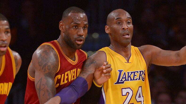 Cleveland Cavaliers forward LeBron James (23) and Los Angeles Lakers forward Kobe Bryant (24) battle for position in the first quarter of the game at Staples Center.