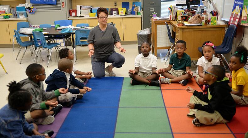 Kindergarten students at Bob Mathis Elementary School do yoga with instructor Sedef Dion earlier this month. Students at the school in DeKalb County get yoga as part of their unstructured time during the day. Administrators and teachers say their students exposed to yoga are more focused, and some students themselves have found it helps with their classwork. A small but growing number of metro Atlanta schools have embraced yoga, though it triggered litigation in Cobb County, where a lawsuit says Christian parents at one school complained that it endorses a non-Christian belief system. KENT D. JOHNSON / AJC