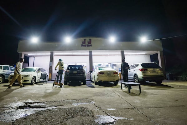 At 1 a.m., customers mingle outside JJ Food Mart, a 24-hour store on Joseph E. Lowery Blvd. NW, on Atlanta's west side. (Miguel Martinez/AJC)