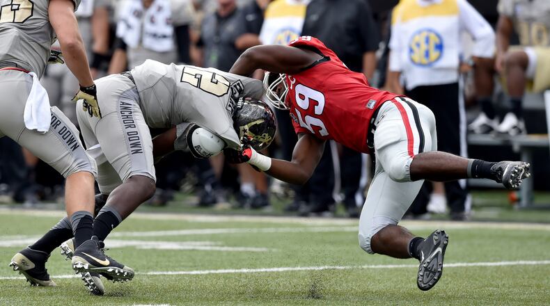 September 12, 2015 Nashville, TN : Georgia Bulldogs linebacker Jordan Jenkins brings down Vanderbilt Commodores quarterback Johnny McCrary during the first half in Nashville Saturday September 12, 2015. BRANT SANDERLIN /BSANDERLIN@AJC.COM