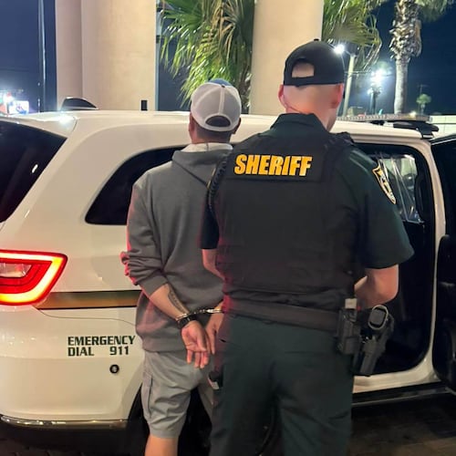 This photo provided by the Okaloosa County Sheriff's Office shows Christopher Gillum being arrested Wednesday, April 22, 2026, at a hotel in Destin, Fla. (Okaloosa County Sheriff's Office via AP)