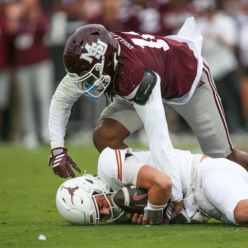 Mississippi State linebacker Derion Gullette, top, sacks Texas quarterback Arch Manning, bottom, during the first half of an NCAA college football game in Starkville, Miss., Saturday, Oct. 25, 2025. (AP Photo/James Pugh)