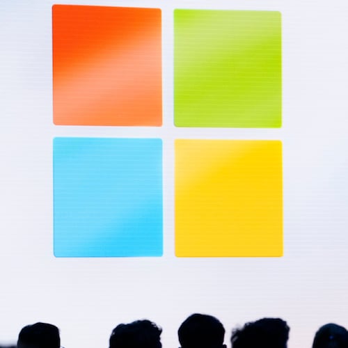 FILE - A Microsoft logo is seen on a screen as people listen at an event at Microsoft headquarters, May 20, 2024, in Redmond, Wash. (AP Photo/Lindsey Wasson, File)