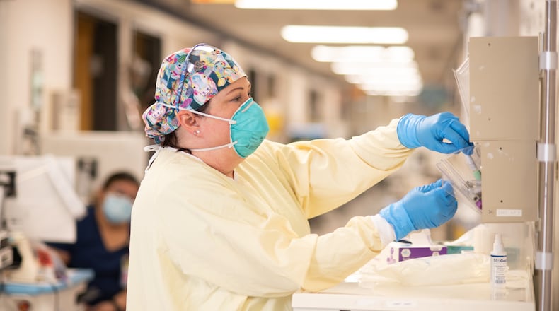 Kelly LaCerra prepares to enter a patient's room in the COVID-19 unit of the ICU at Northeast Georgia Medical Center. LaCerra, a charge nurse in the COVID-19 ICU unit, and two physicians who pronounced dozens of deaths say they are just now beginning to process what they saw. (Contributed)
