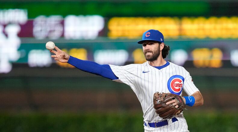 Chicago Cubs' Dansby Swanson throws to first in a baseball game against the New York Mets Tuesday, May 23, 2023, in Chicago. (AP Photo/Charles Rex Arbogast)
