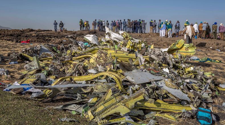 FILE - Wreckage is piled at the crash scene of Ethiopian Airlines flight ET302 near Bishoftu, Ethiopia, March 11, 2019. (AP Photo/Mulugeta Ayene, File)