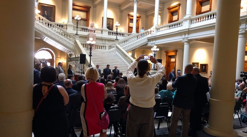 Franklin Holmes of Newton County captures the moment as son Steven signs his commitment to attend the GA CATT program, known as the "German apprentice" program because it's based on that country's apprenticeship system.