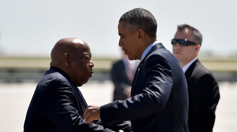 President Obama is greeted by U.S. Rep. John Lewis at the airport. BRANT SANDERLIN/BSANDERLIN@AJC.COM