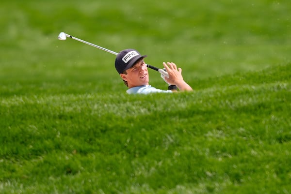 Mason Howell (peekaboo!) hits a shot on the 18th hole during his Tuesday practice round at the U.S. Open.