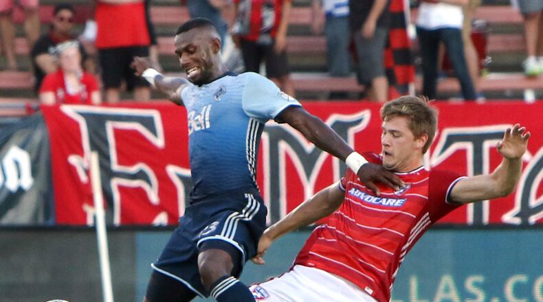 FC Dallas' Walker Zimmerman (25) stretches to steal the ball from Vancouver Whitecaps' Bernie Ibini-lsei (23) during the first half of an MLS soccer match in Frisco, Texas, Saturday, July 29, 2017. (Steve Hamm/The Dallas Morning News via AP)