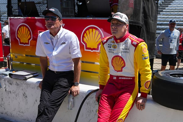 President of Team Penske Tim Cindric, left and driver Josef Newgarden wait for the start of during practice for the Indianapolis 500 auto race at Indianapolis Motor Speedway in Indianapolis, Sunday, May 18, 2025. (AP Photo/Michael Conroy)