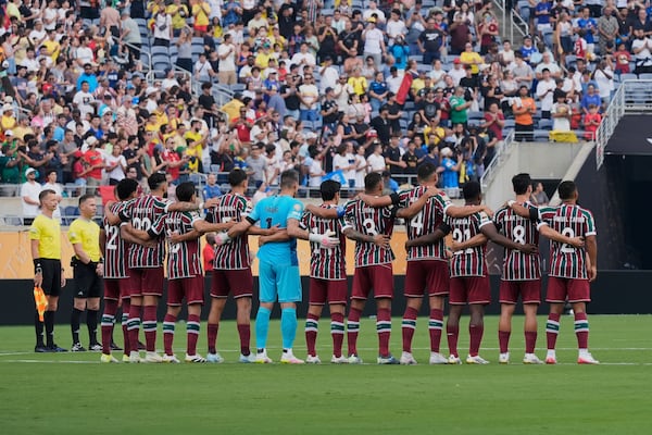 Players of the two teams observe a minute of silence in memory of Portugal international and Liverpool player Diogo Jota and his brother Andre Silva, before the Club World Cup quarterfinal soccer match between Fluminense and Al Hilal in Orlando, Fla., Friday, July 4, 2025. (AP Photo/John Raoux)
