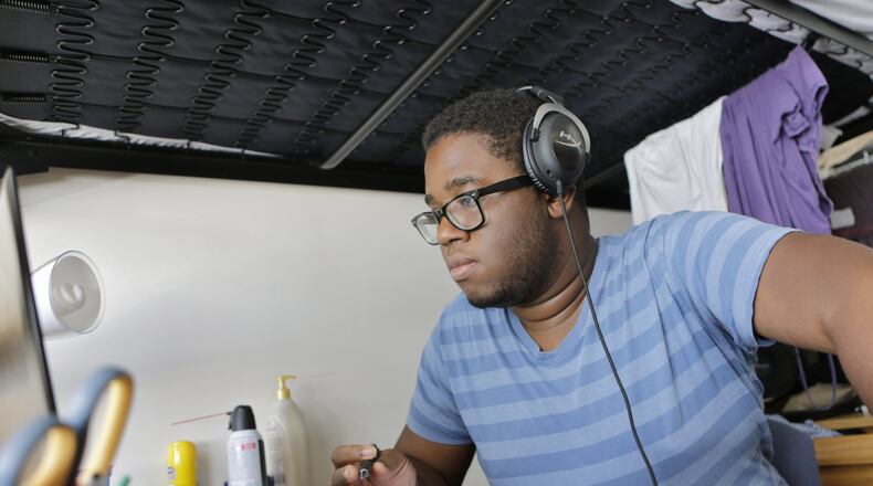 Anthony Sobowale studies in his dorm room for his organic chemistry class at Georgia State University. He says an online credit recovery class when he was a high school student in Douglas County was not the best way for him to learn. BOB ANDRES /BANDRES@AJC.COM