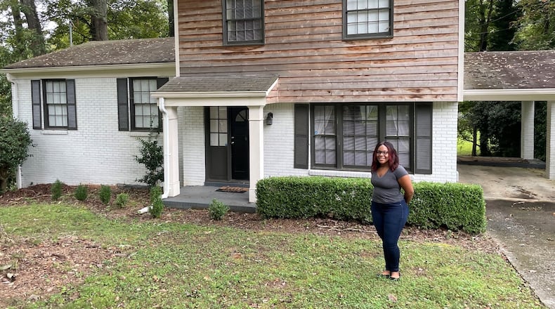 Shaina Riggins moved into this refurbished 1960s ranch home in the historic Collier Heights neighborhood in 2020. This year she was cited by the city for having painted bricks, a job performed before her purchase. Photo by Bill Torpy