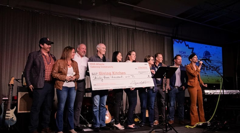 Members of the Atlanta catering community present a check to Giving Kitchen at its annual fundraiser in February. The nonprofit, honored this week by the James Beard Foundation, provides emergency relief funds to restaurant workers and employees of catering operations, food trucks and concessions stands. CONTRIBUTED BY THE GIVING KITCHEN