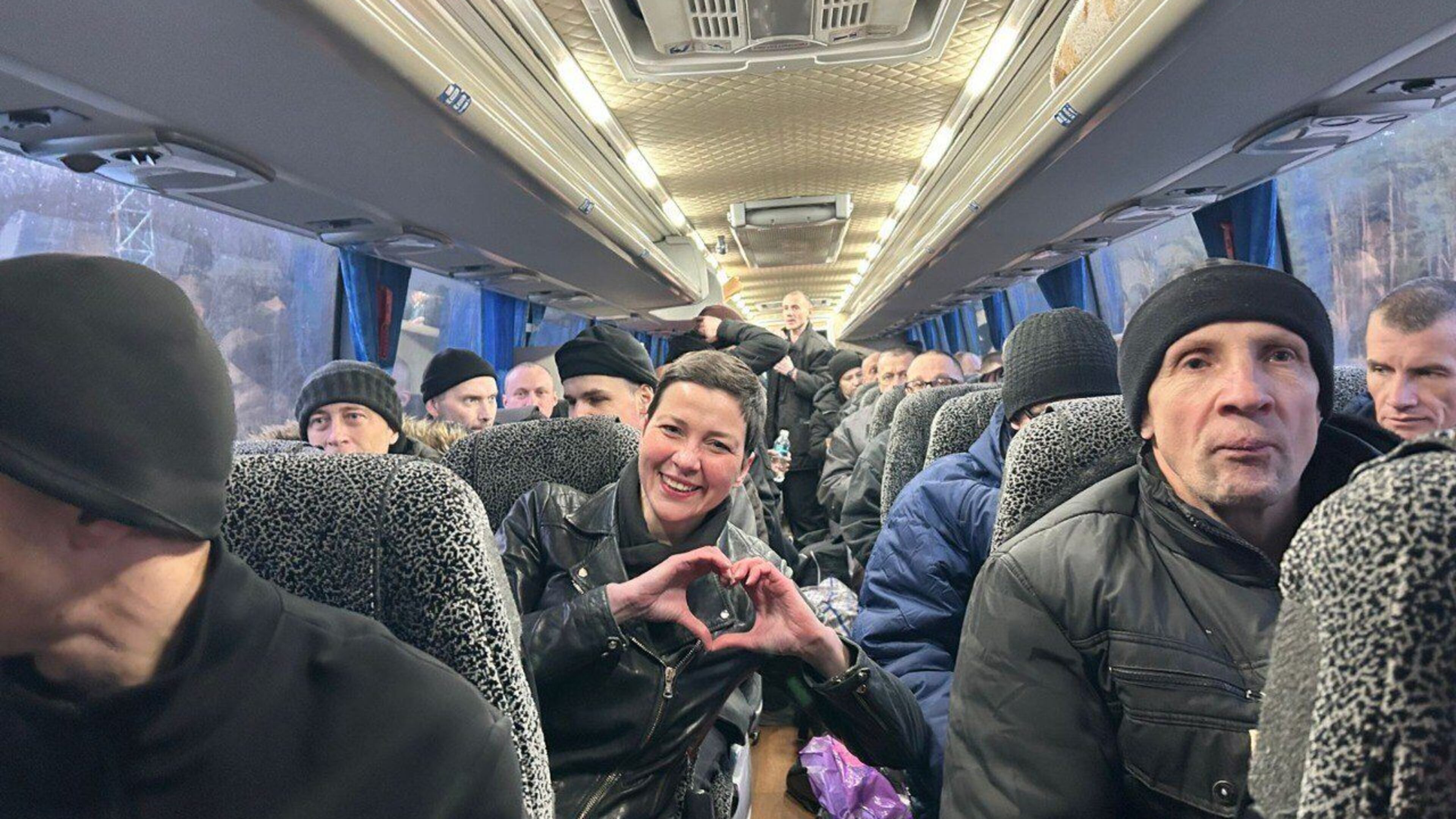 In this photo provided by the Press Service Of Coordination Headquarters for the Treatment of Prisoners of War on Saturday, Dec 13, 2025, Maria Kolesnikova, key Belorussian opposition figure, shows a sign of love siting in a bus after been released from detention in Belarus, at the Ukrainian Belorussian border. (Press Service Of Coordination Headquarters for the Treatment of Prisoners of War via AP)