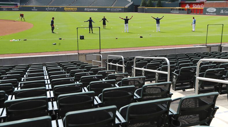 Truist Park seats are empty as Braves players loosen up during the first workout of summer camp on Friday July 3, 2020, in Atlanta.