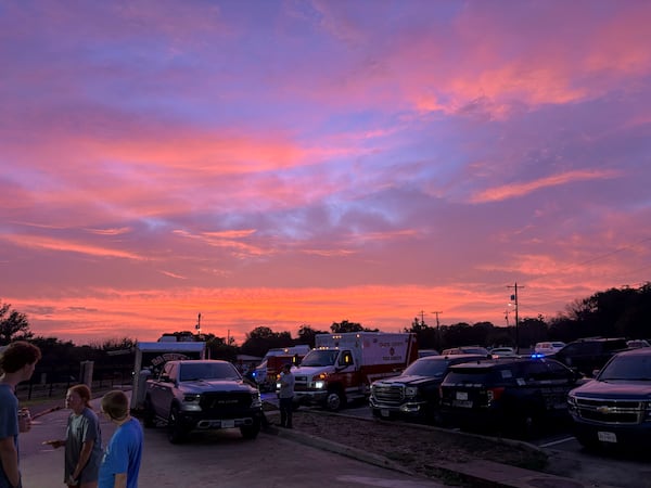 The sun sets as flooding victims gather at the Ingram, Texas, Elementary School at 8:55 p.m. on Friday, July 4, 2025. (Shabd Simon-Alexander via AP)