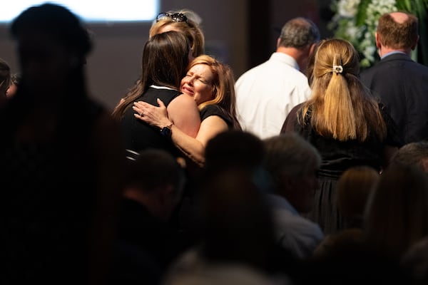 Nic Crews' mother, Kim Morris, hugs a person before the start of Crews' funeral at North River Church of Christ in Marietta on Sunday, March 22, 2026. (Ben Gray for the AJC)