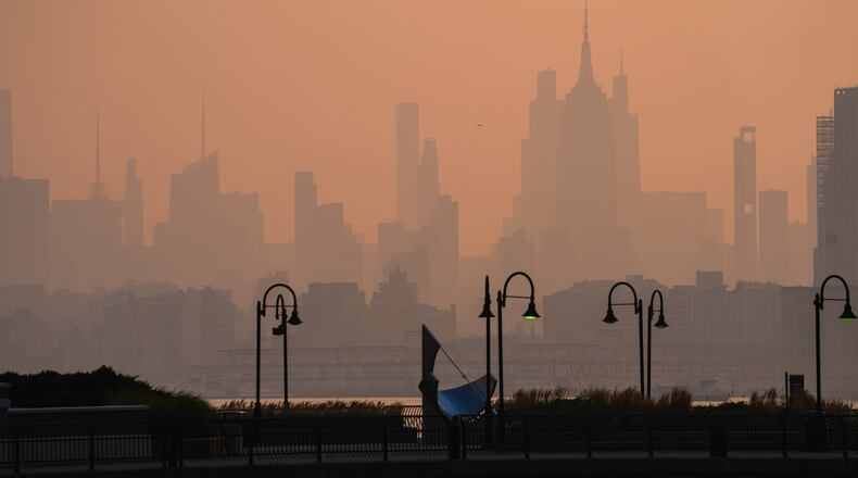 The New York City skyline is seen through a cover of wildfire smoke, in Jersey City, N.J., Friday, July 17, 2026. (AP Photo/Ryan Murphy)