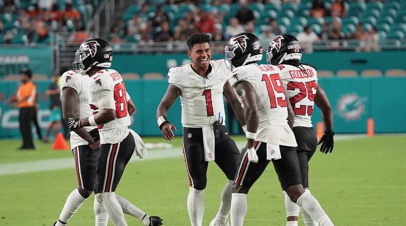 Atlanta Falcons quarterback Tua Tagovailoa (1) celebrates with teammates during the first half of an NFL preseason football game against the Miami Dolphins, Friday, Aug. 28, 2026, in Miami Gardens, Fla. (AP Photo/Lynne Sladky)