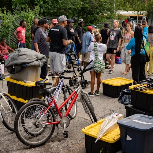A bus waits to move over 20 homeless people from the Old Wheat Street encampment to Welcome House on Thursday, July 10, 2025. Atlanta has long treated homelessness not as a structural failure but as a public nuisance to be hidden and criminalized, writes AJC guest columnist Carson Bohl. (Ben Hendren for the AJC)