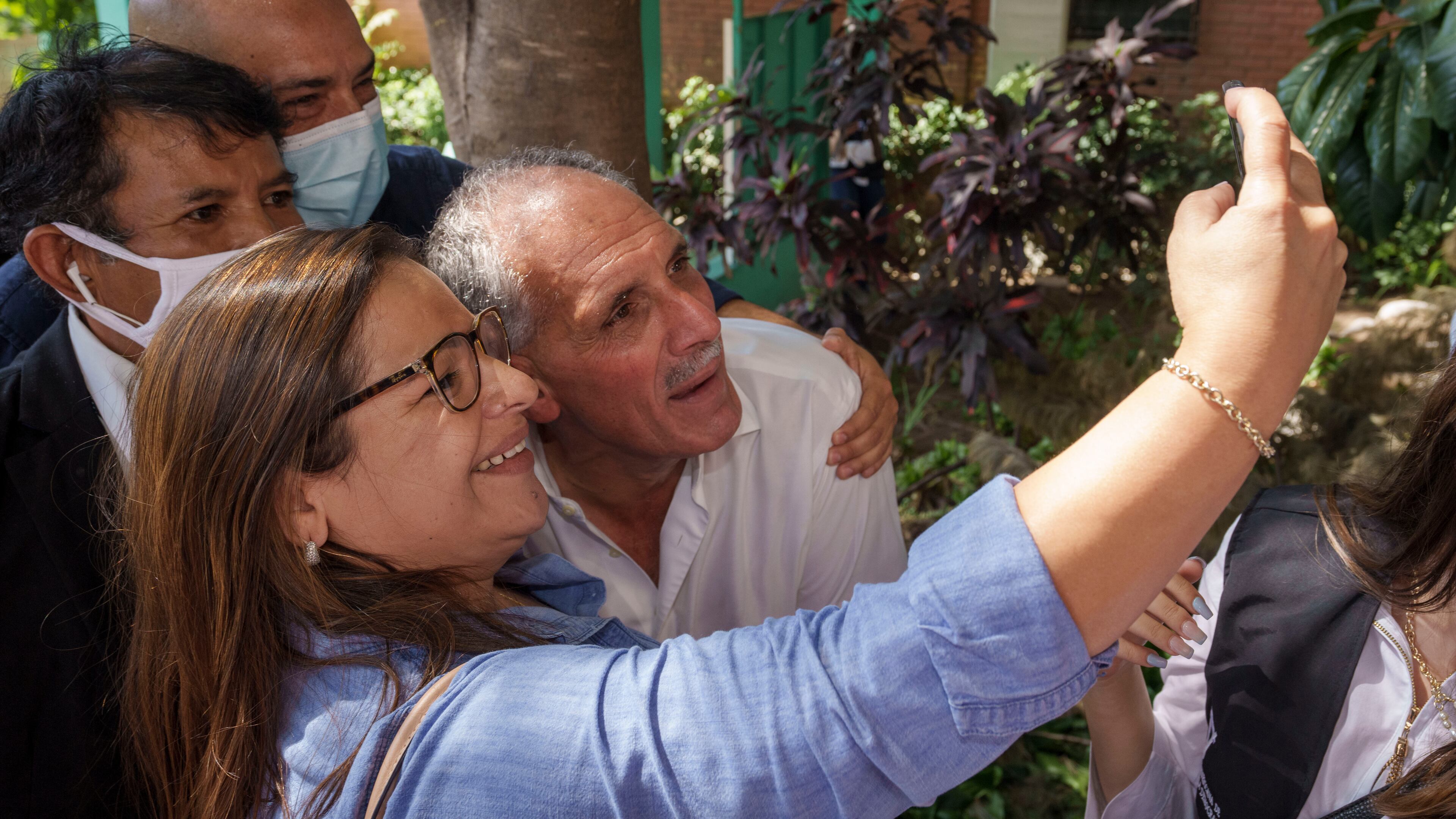 FILE - National Party presidential candidate Nasry Asfura poses for a selfie with a supporter, after voting at a polling station in the general elections in Tegucigalpa, Honduras, Nov. 28, 2021. (AP Photo/Moises Castillo, File)