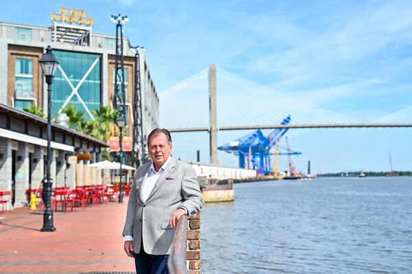 Richard C. Kessler on the portion of the River Walk in front of District Live, the Talmadge Memorial Bridge and the Georgia Ports Authority along the Savannah River. (Sarah Peacock for The Atlanta Journal-Constitution)