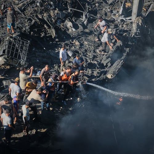 Palestinians try to extinguish a fire in the rubble of a destroyed building following an Israeli airstrike in Gaza City, Monday, Aug. 24, 2026. (AP Photo/Jehad Alshrafi)