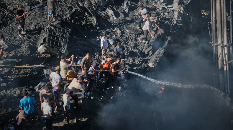 Palestinians try to extinguish a fire in the rubble of a destroyed building following an Israeli airstrike in Gaza City, Monday, Aug. 24, 2026. (AP Photo/Jehad Alshrafi)
