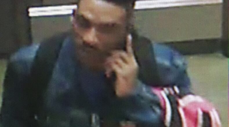Georgia State University police believe this man, shown in surveillance footage from a previous theft on-campus, is also responsible for robbing a student at gunpoint Tuesday inside a school library. (Credit: Georgia State University police)