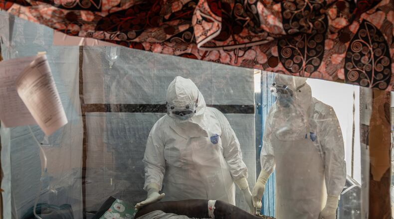 Health workers tend to an Ebola patient at the Rwampara Treatment Center in Ituri, Congo, Thursday, June 18, 2026. (AP Photo/Moses Sawasawa)