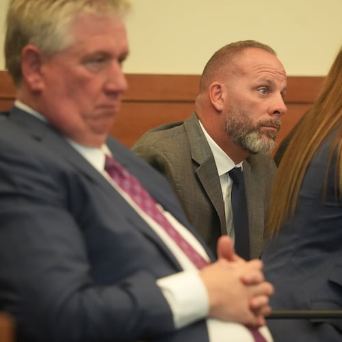 Jason Meade, center, sits with his attorneys Mark Collins, left, and Kaitlyn Stephens, right, during opening statements in the retrial of the former Ohio sheriff's deputy charged with murder and reckless homicide in the 2020 killing of Casey Goodson Jr., inside Franklin County Common Pleas Court in Columbus, Ohio, Thursday, April 23, 2026. (Doral Chenoweth/Pool photo via AP)